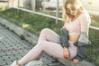 Portrait of Young and Beautiful Woman in Casual Clothes in the Street. Dressed in Pink Shirt and Pants. Spring, Summer Concept. Relax Time. Girl with Sunglasses. Enjoy City Sunset.