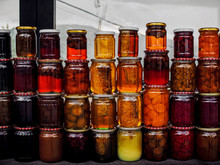 Stacks Of Jars With Honey And Pickled Fruits On Market At Armenia