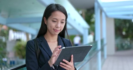 Wall Mural - Young business woman use of digital tablet computer at outdoor