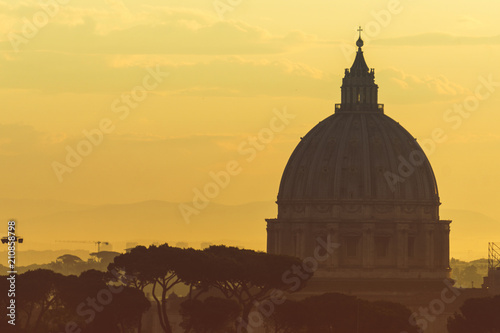 Fotografía St Peter's basilica dome at sunrise in Rome, Italy