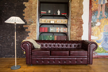 Wall Mural - Interior of the room in old style with a leather sofa