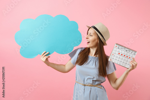 Fotografie, Obraz Woman in blue dress, hat holding empty blank Say cloud, speech bubble, female periods calendar, checking menstruation days isolated on background