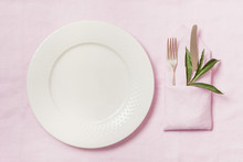 Romantic Dinner. Elegance Table Setting With Plant On Pink Linen Tablecloth. Top View.