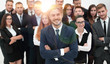 © ASDF - smiling businessman standing on background of her business team.