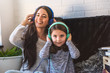 © lordn - Girls having fun at home, listening music over smart phone. Family quality time