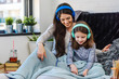 © lordn - Girls having fun at home, listening music over smart phone. Family quality time