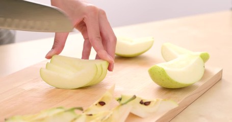 Canvas Print - Cutting apple on the cutting board