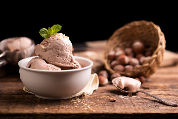 Wall Mural - Fresh hazelnut ice cream on wooden table.