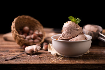 Wall Mural - Fresh hazelnut ice cream on wooden table.