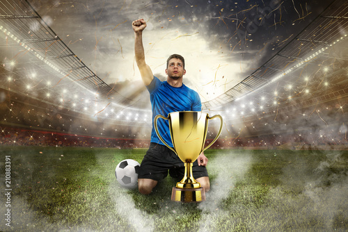 Photographie Golden winner's cup in the middle of a stadium with audience