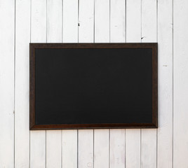 black wooden picture frame on a white wooden wall