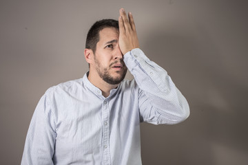 man in pain throwing his hand to his face