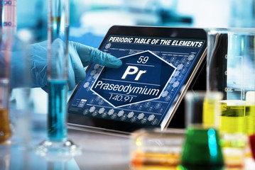 Poster - researcher working on the digital tablet data of the chemical element Praseodymium Pr / researcher working on the computer with the periodic table of elements 