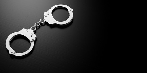 Metal handcuffs isolated on black background, 3d illustration