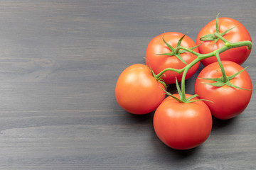 Tomatoes on a dark table