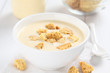 © Ildi - Homemade traditional Danish cold buttermilk koldskal dessert soup with pieces of crisp kammerjunkere cookies (Selective Focus, Focus in the middle of the bowl)