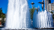 Space Needle, Seen Trough A Water Fountain With A Blue Sky. Seattle, Washington. USA.