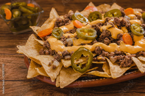 Cuadros en Lienzo nacho chips corn garnished with ground beef, melted cheese, jalapeños peppers in