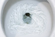 selective focus close up flushing toilet bowl for sanitary, Toilet, Flushing Water, close up, water flushing in toilet, A photo of a white ceramic toilet bowl in the process of washing it off. Ceramic