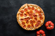 © Vladislav Noseek - Pepperoni pizza on black concrete background. American pepperoni pizza, top view