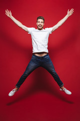 Wall Mural - Full length portrait of a cheerful young bearded man