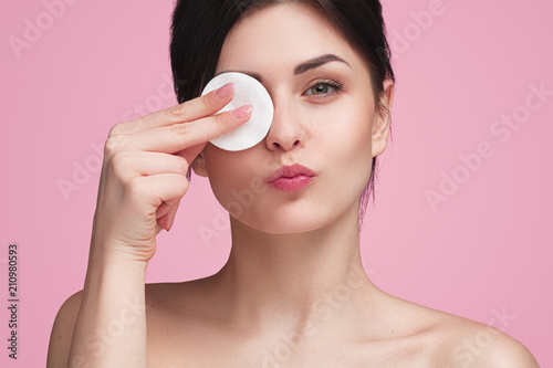 Fotografering Beautiful woman with cotton pad in studio