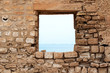 © Ruslan Grebeshkov - Stone wall with a square opening. Sea view. Old fortress. The Island Of Djerba. Tunisia
