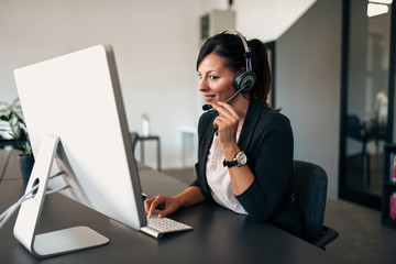 Canvas Print - Lovely businesswoman using headset.