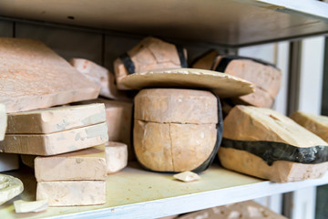 Various unpainted clay items on shelf