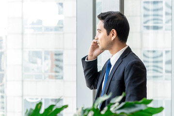 Asian businessman calling on mobile phone