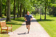 © michaelheim - Mature man running in park on sunny day