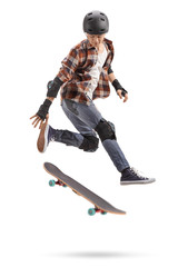 Wall Mural - Teenage skater boy with protective equipment jumping