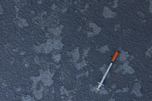 Dirty Drug Addict Needle Discarded On City Sidewalk