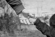 © Kostia - Old photo of the hand of a parent and child in the nature on a park background