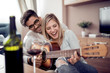 © ivanko80 - Young couple enjoying wine at home