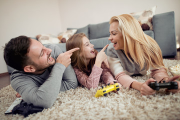 Wall Mural - Playful family playing video games together