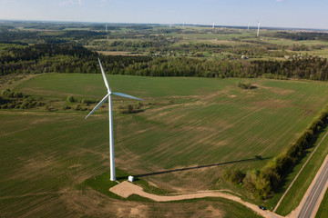 Aerial view of windmill on the field on sunny spring day. Concep