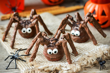 Wall Mural - Halloween spider cakes with candy eyes in chocolate, Halloween treats for kids