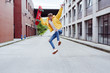 © ADDICTIVE STOCK - Happy and excited teenager jumping with skateboard