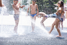 Children Play In The Fountain