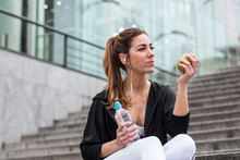 Athletic Woman With Apple And Water On Steps