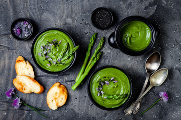 Sticker - Homemade green spring asparagus cream soup decorated with black sesame seeds and edible chives flowers