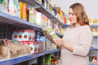 © JackF - Smiling woman buyer with assortment of grocery food store
