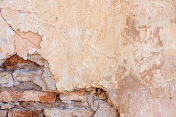 Wall Mural - Old Cracked Weathered Shabby Yellow Painted Plastered Peeled Brick Wall Background.