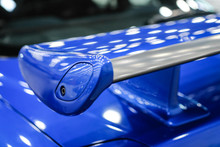 Blue Racing Spoiler On The Car Close-up. The Concept Of A Sports Car.
