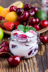 Wall Mural - Healthy breakfast with sweet cherry yogurt and fresh  summer fruits