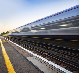 Wall Mural - Express trains passing through a UK station at speed