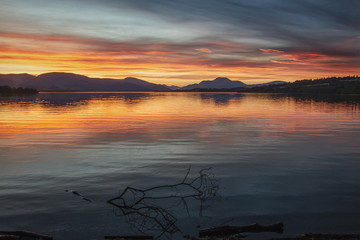 Beautiful sunset andscape with lake Loch Lomond and hills in Scotland