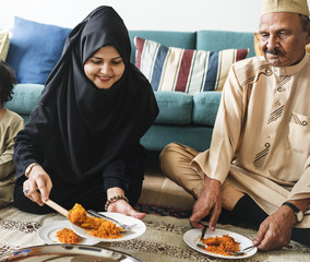 Wall Mural - Muslim family having dinner on the floor