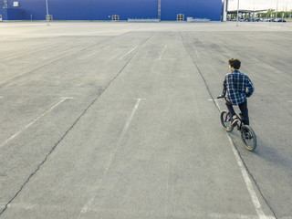 Wall Mural - young street urban rider on the bmx bike in the street aerial view